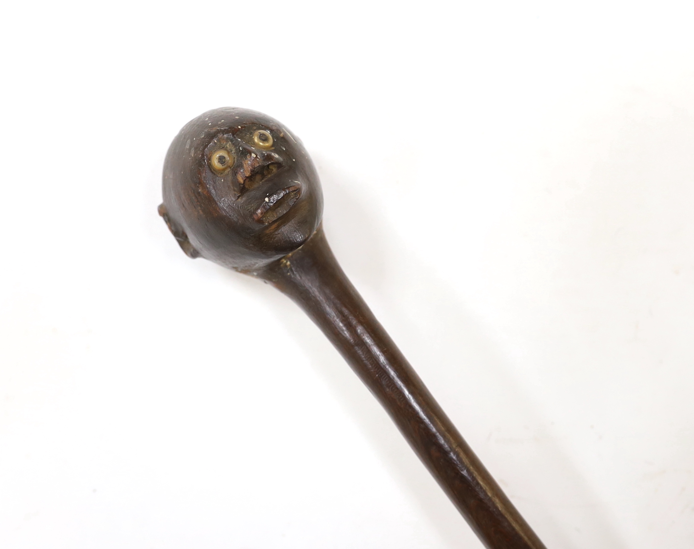 An African carved ebony walking stick, Gogo tribe, Tanzania, with inset eyes, 128cm (damage to foot)